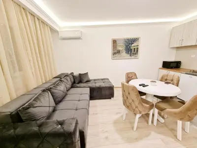 a living room with a couch and a table at Modern Central Apartments RENOVATED in Belgrade