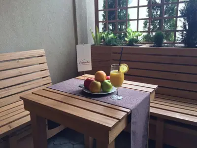 a table with a plate of fruit and a glass of juice at B&B Villa Panuka in Pančevo