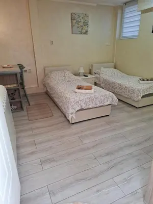 a bedroom with two beds and a wooden floor at Apartment Sleep'n Drive in Belgrade