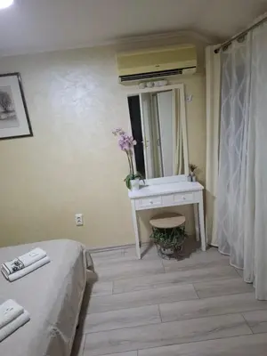 a bedroom with a bed and a sink and a mirror at Apartment Sleep'n Drive in Belgrade