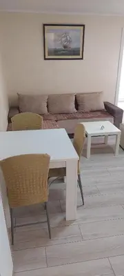 a living room with a couch and a table and chairs at Apartment Sleep'n Drive in Belgrade