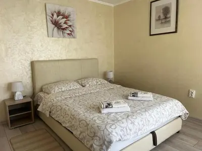 a bedroom with a bed with two towels on it at Apartment Sleep'n Drive in Belgrade