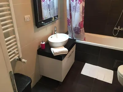 a bathroom with a sink and a toilet and a tub at Apartment Gorki in Belgrade