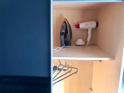 two pictures of a room with a hair dryer on a shelf at Apartment Arena Silver in Belgrade