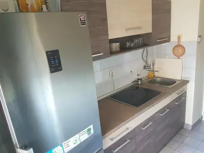 a small kitchen with a sink and a refrigerator at Apartment Arena Silver in Belgrade