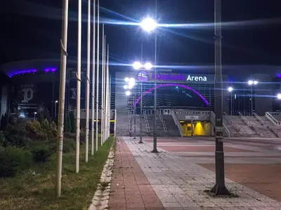 a stadium at night with lights and a building at Apartment Arena Silver in Belgrade