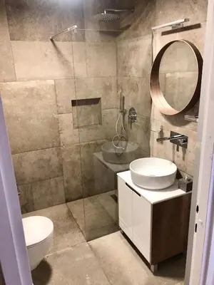 a bathroom with a toilet and a sink and a mirror at Apartment Arena Silver in Belgrade