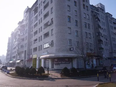 a tall white building on a city street at Apartment Arena Silver in Belgrade