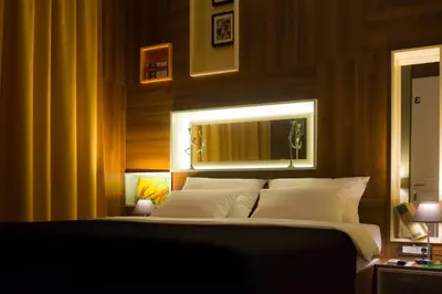 a bedroom with a large bed with white pillows at B&B Wimbledon Garni Concept in Belgrade