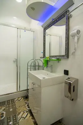 a bathroom with a sink and a mirror at B&B Wimbledon Garni Concept in Belgrade
