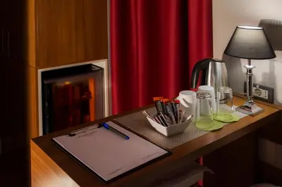 a desk with a lamp and a paper on it at B&B Wimbledon Garni Concept in Belgrade