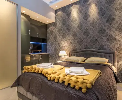 a bedroom with a large bed with towels on it at Nusha Apartments in Belgrade