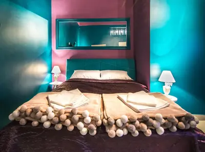 a bedroom with a large bed with two pillows at Nusha Apartments in Belgrade