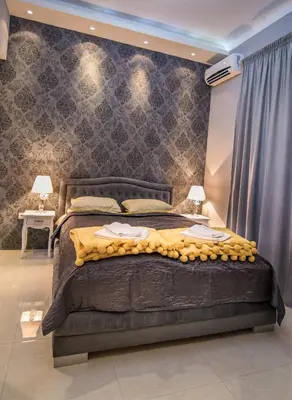 a bedroom with a large bed in a room at Nusha Apartments in Belgrade