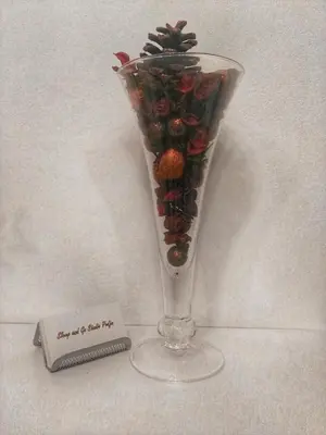 a glass vase with fruit in it next to a thermometer at Sleep and Go Pedja in Belgrade