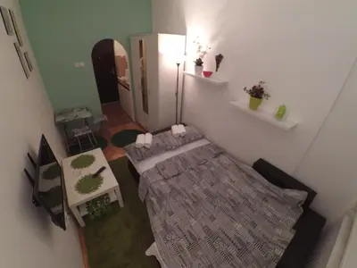 a small room with a bed and a mirror at Sleep and Go Pedja in Belgrade