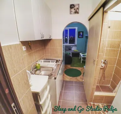 a small kitchen with a sink and a sink at Sleep and Go Pedja in Belgrade