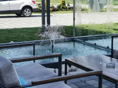 a water fountain in the middle of a patio at Hotel Crystal in Pećinci
