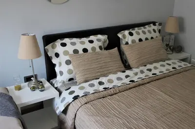 a bedroom with a bed with pillows and a side table at Apartment Skadarlija FREE parking in Belgrade