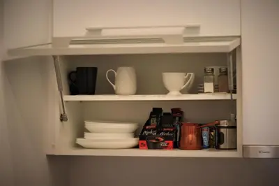 a cupboard with plates and utensils on it at Apartment Skadarlija FREE parking in Belgrade