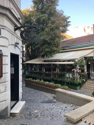 a flower shop with a sign hanging off the side of a building at Apartment Skadarlija FREE parking in Belgrade