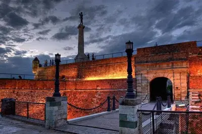 a large brick wall with a statue on top of it at Apartment River Walk in Belgrade