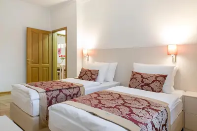 a hotel room with two beds and a door at Central Belgrade Apartment 4 in Belgrade