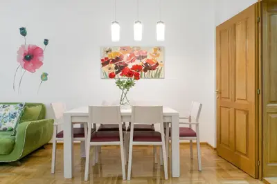 a dining room with a white table and chairs at Central Belgrade Apartment 4 in Belgrade