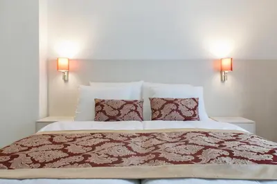 a bedroom with a large bed with two pillows at Central Belgrade Apartment 4 in Belgrade