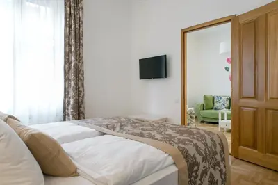 a bedroom with a bed and a tv and a couch at Central Belgrade Apartment 4 in Belgrade