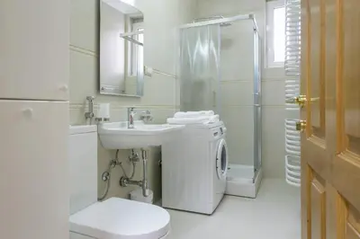 a bathroom with a sink and a toilet and a shower at Central Belgrade Apartment 4 in Belgrade