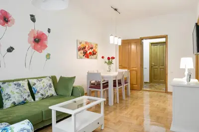 a living room with a green couch and a table at Central Belgrade Apartment 4 in Belgrade