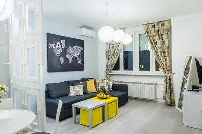 a living room with a couch and a table at Bohemian Quarter Apartment -1 Min to Skadarlija - Walk Everywhere in Belgrade