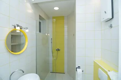 a bathroom with a shower with a mirror and a sink at Bohemian Quarter Apartment -1 Min to Skadarlija - Walk Everywhere in Belgrade