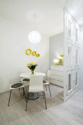 a white dining room with a white table and chairs at Bohemian Quarter Apartment -1 Min to Skadarlija - Walk Everywhere in Belgrade