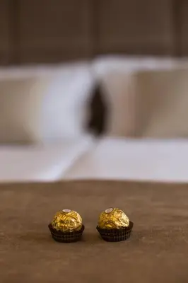 two small gold muffins sitting on a table at Aria Royal Nusic apartment in Belgrade