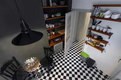 a kitchen with a black and white checkered floor at Apartment Vivian in Belgrade