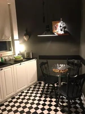 a kitchen with a table and two chairs and a counter at Apartment Vivian in Belgrade
