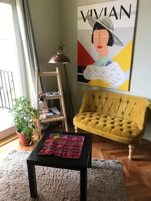 a living room with a yellow couch and a table at Apartment Vivian in Belgrade