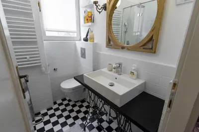 a bathroom with a sink and a mirror and a toilet at Apartment Vivian in Belgrade