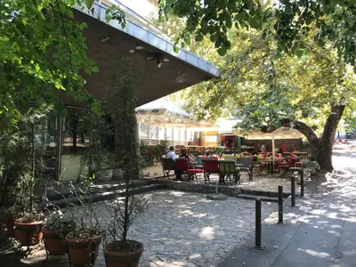 a patio with tables and chairs under a building at Apartment Vivian in Belgrade