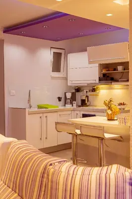 a kitchen with white cabinets and a purple ceiling at #1 Lux Villa with Pool, Gameroom, Spa, Zen Yard #Free airport transport# in Belgrade