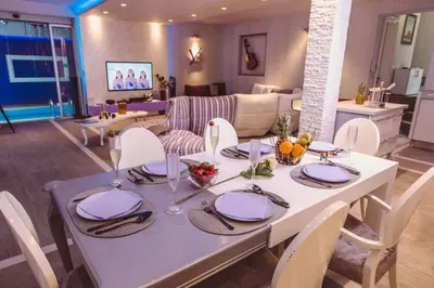 a white dining room table with chairs and a living room at #1 Lux Villa with Pool, Gameroom, Spa, Zen Yard #Free airport transport# in Belgrade