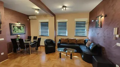 a living room with a couch and a table at Apartment StefanA in Belgrade