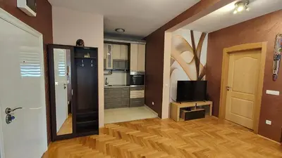 a room with a kitchen and a hallway with a television at Apartment StefanA in Belgrade