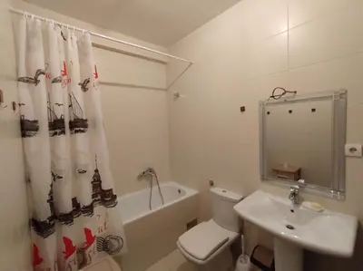 a bathroom with a toilet and a sink and a shower curtain at Apartment StefanA in Belgrade