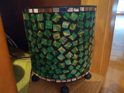 a green and black vase with wheels on a table at Apartment StefanA in Belgrade