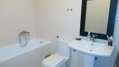 a white bathroom with a toilet and a sink at Apartment StefanA in Belgrade