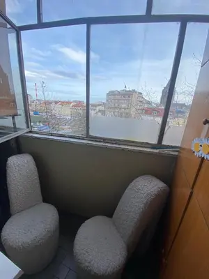 a room with two chairs and a large window at Apartman Skadarlija in Belgrade