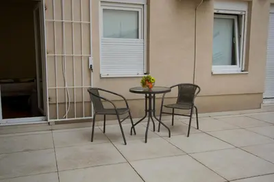a table and two chairs on a patio at Lux Life Apartment in Belgrade